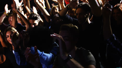 group of people dancing at a concert 4k