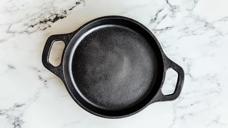 black cast iron skillet on marble countertop