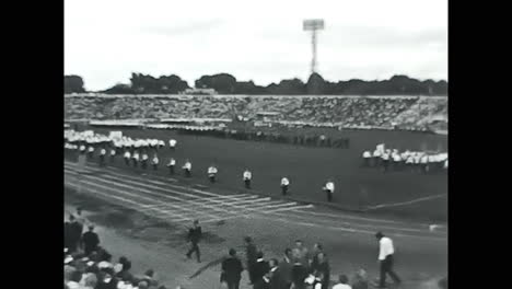 crowd watching marching band. circa ussr 1970: crowd watching marching band