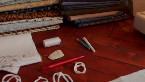 workstation of tailor or dressmaker in slow motion with various tools visible