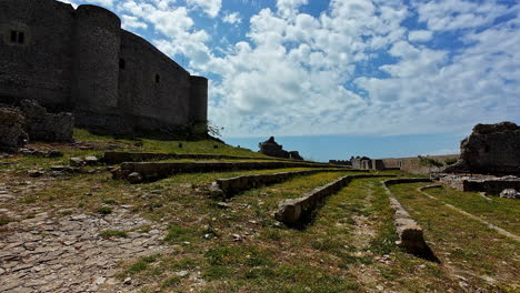 Dolly-at-the-Chlemoutsi-Castle-Museum-inner-garden-with-the-castle-walls-at-the-back,-13th-century-castle-Frankish-rule-in-Greece