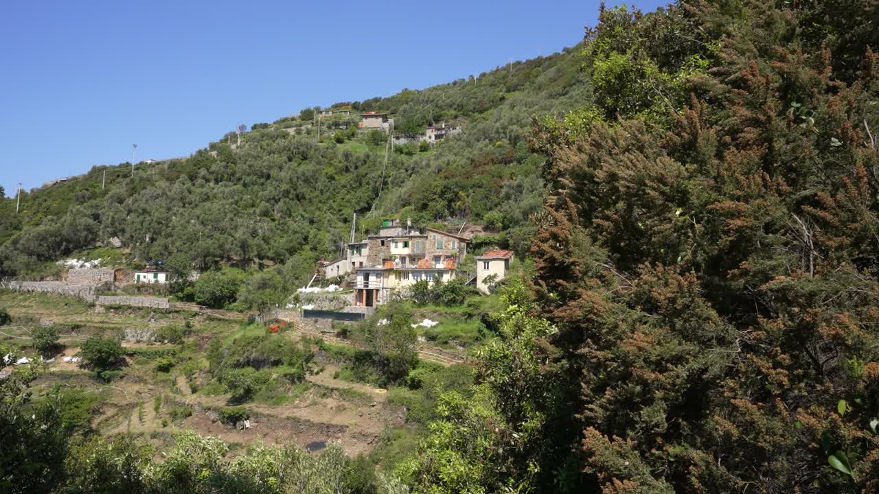 An old house in the middle of the national park of cinque terre on the mountains by the sea.