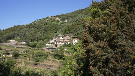 an old house in the middle of the national park of cinque terre on the mountains by the sea.