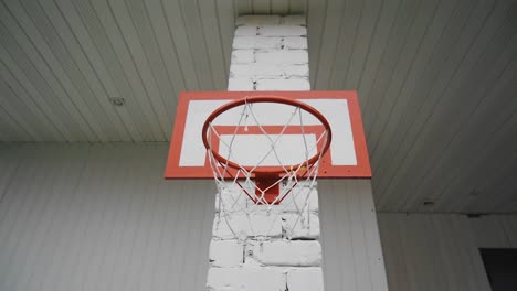 shooting a red basketball net close-up. playing basketball in the yard