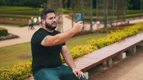 Young-man-making-a-video-call-from-his-mobile-phone-outdoors