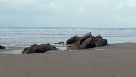 Spain's-jagged-and-rocky-coastline-is-defined-by-waves-crashing-on-the-horizon,-capturing-a-tranquil-daytime-vista-of-natural-beauty