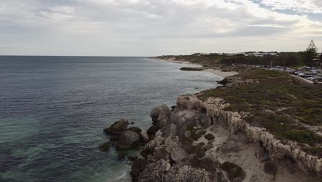 Aerial-Rise-Up-Shot-Over-Rocky-Coastline,-Burns-Beach-Perth-Australia