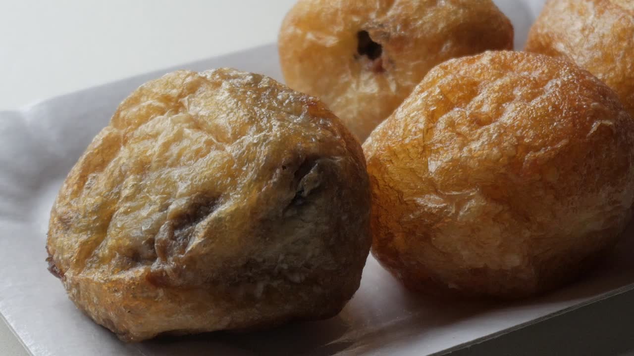 Delicious stuffed Profiterole with chocolate inside, close up sweet dessert on a plate for halloween