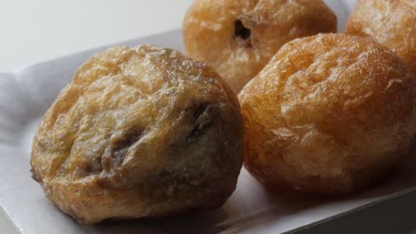 delicious stuffed profiterole with chocolate inside, close up sweet dessert on a plate for halloween