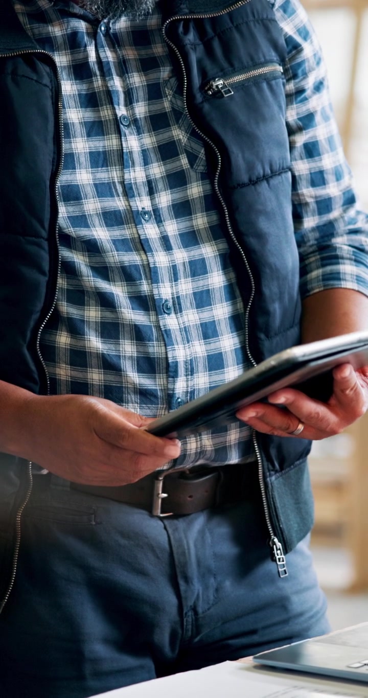 Two Professionals Discussing Project Details on a Digital Tablet