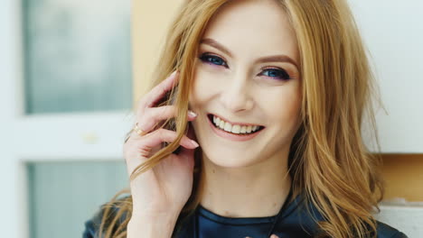 Beautiful-Woman-With-Long-Hair-Talking-On-The-Phone-Outdoors