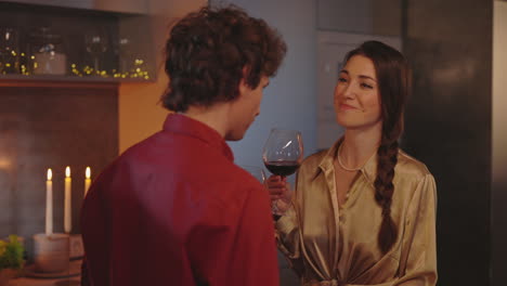 couple enjoying red wine together in a cozy home setting