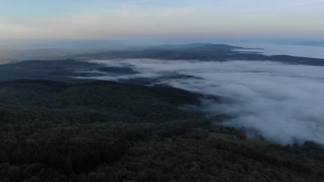 Low-clouds-over-rural-landscape-at-sunset