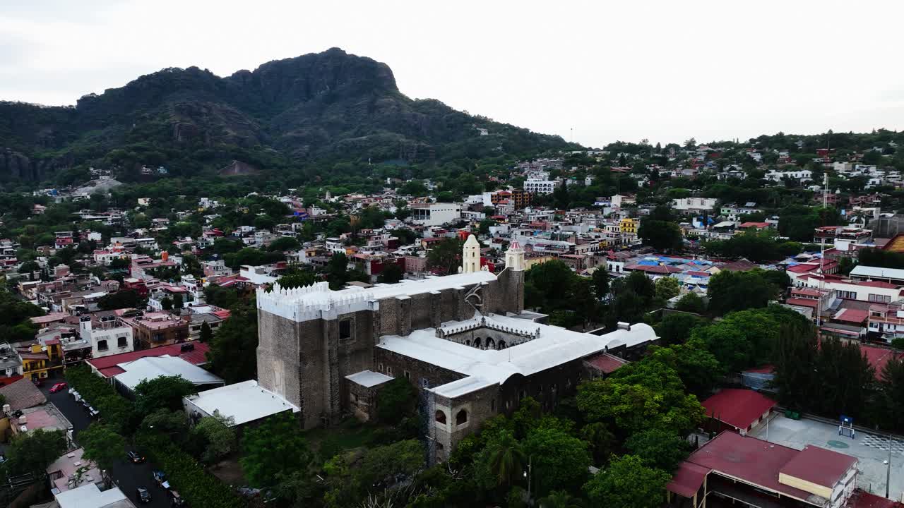 Aerial view around the Parroquia Nuestra Se&ntilde;ora de la Natividad in Tepoztlan, Morelos, cloudy Mexico