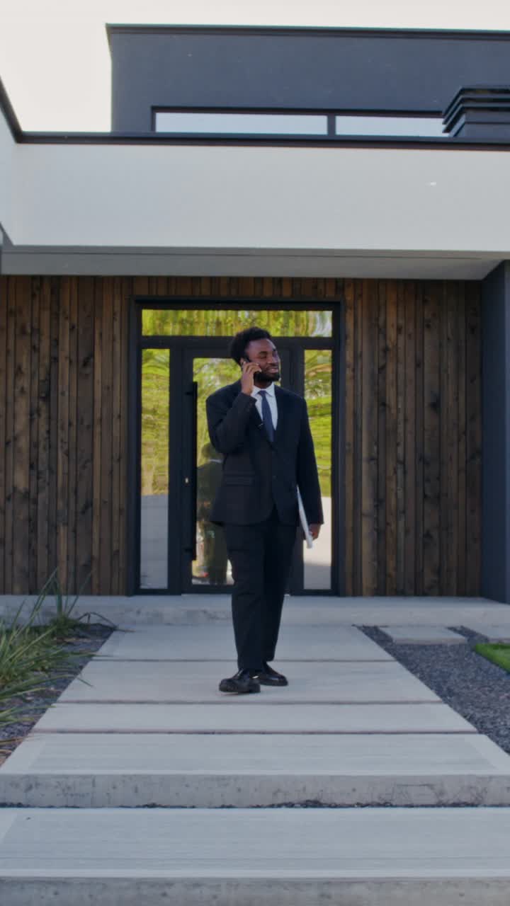 Businessman Talking on Phone at Modern Home