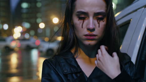 a woman crying in the rain at night
