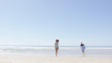 Surfers-Walking-Away-from-Ocean