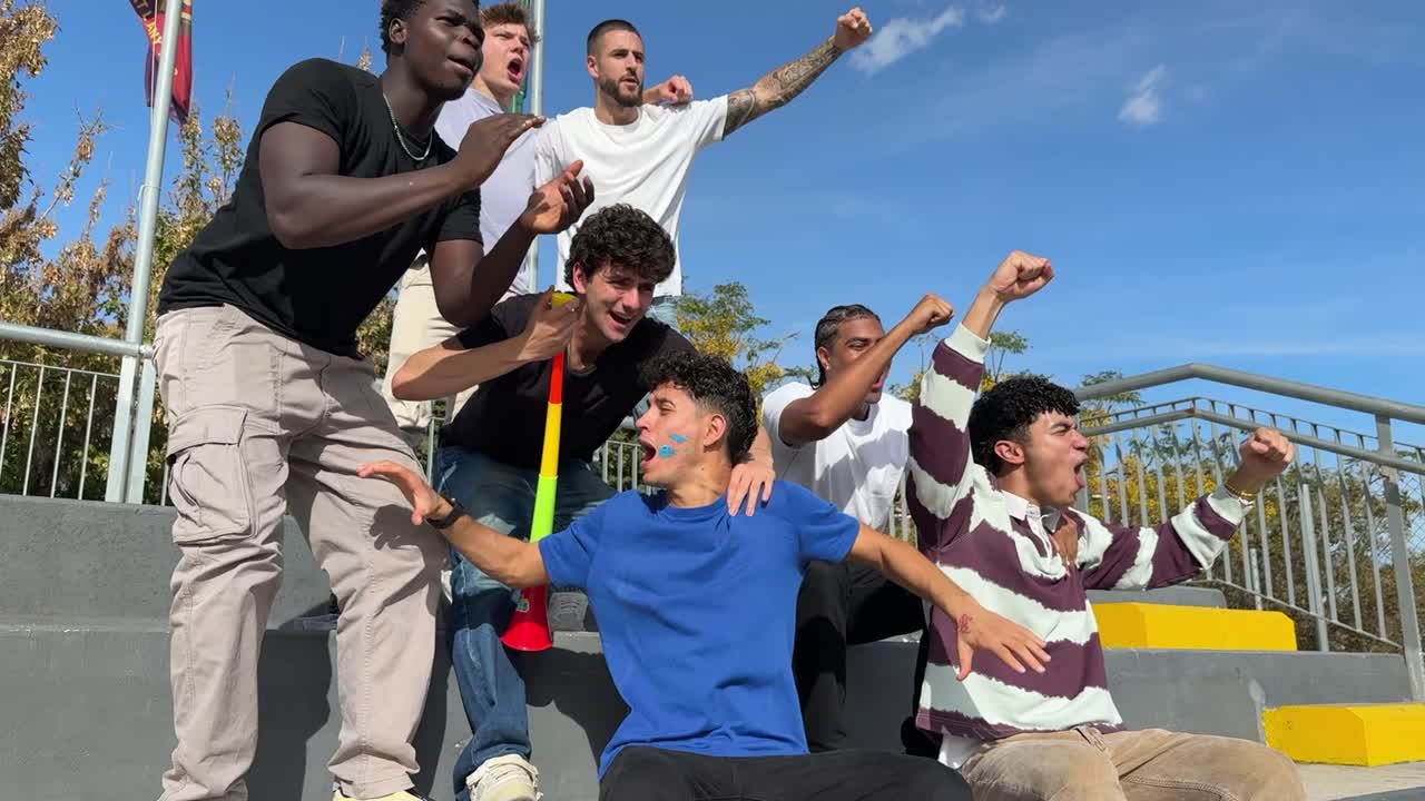 A group of young men celebrating outdoors
