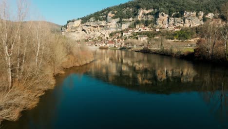 wide-angle drone shot of la roque-gageac with cliffs