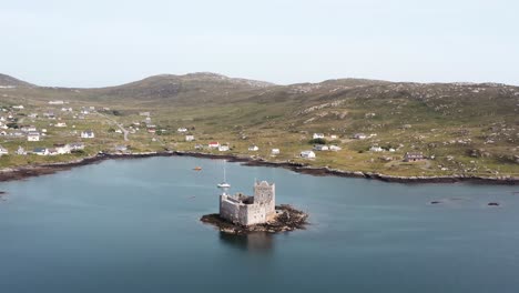 Drone-"point-of-interest"-shot-of-Kisimul-castle-and-Castlebay-on-the-Isle-of-Barra-in-the-Outer-Hebrides