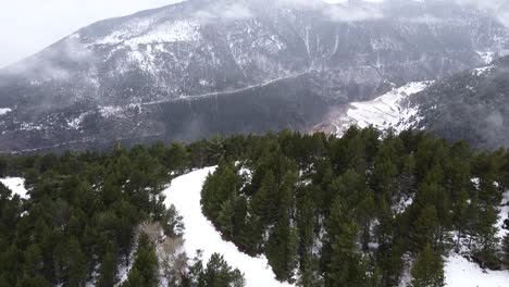 Drone-shot-flying-over-snow-capped-mountaintops-in-the-Pyrenees-mountains