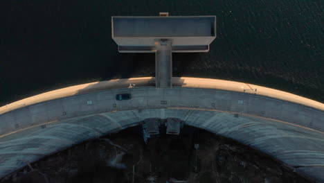 dam wall dramatic light birdseye dolly car passing by on lake barragem do alto rabagao montalegre