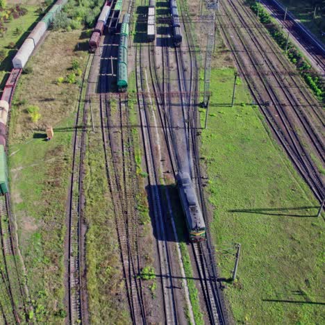 aerial view of a train yard with freight cars and a locomotive