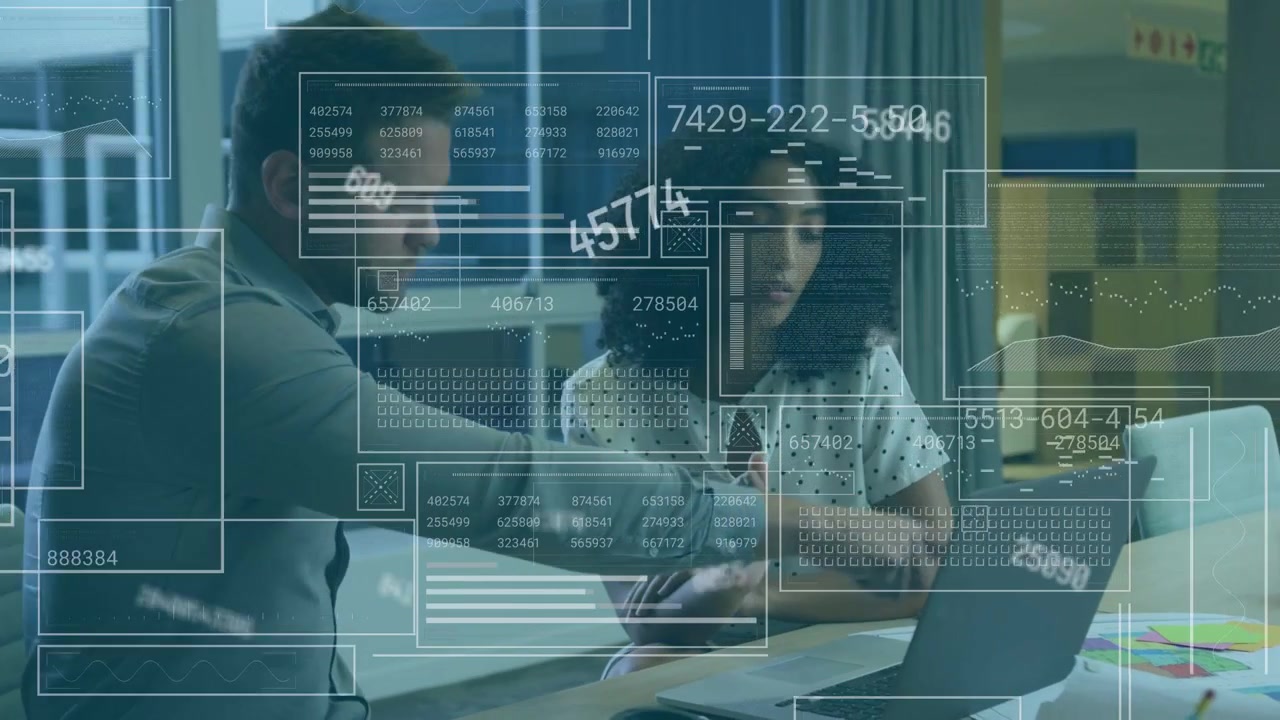 Showing smartphone, woman polka-dot blouse, man grey shirt reviewing charts on laptop at office HUD