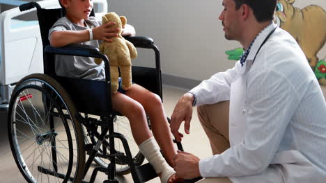 male doctor interacting with child patient in ward