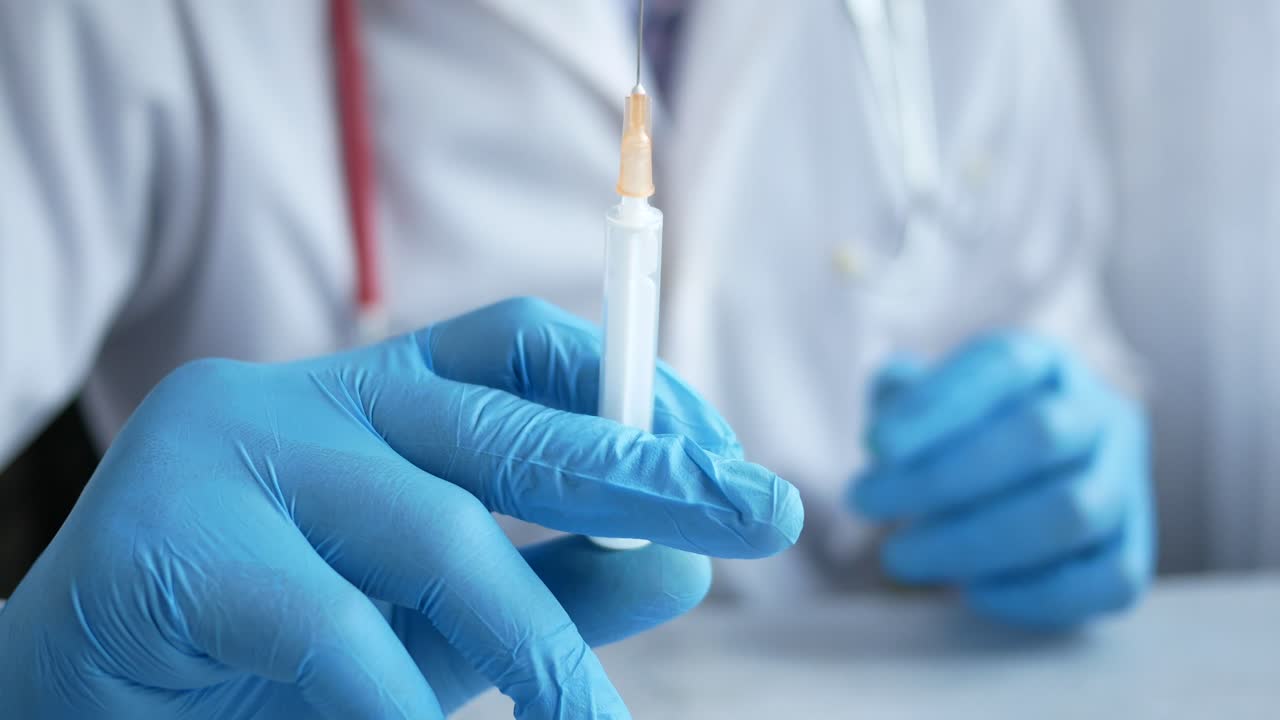 Doctor holding a syringe