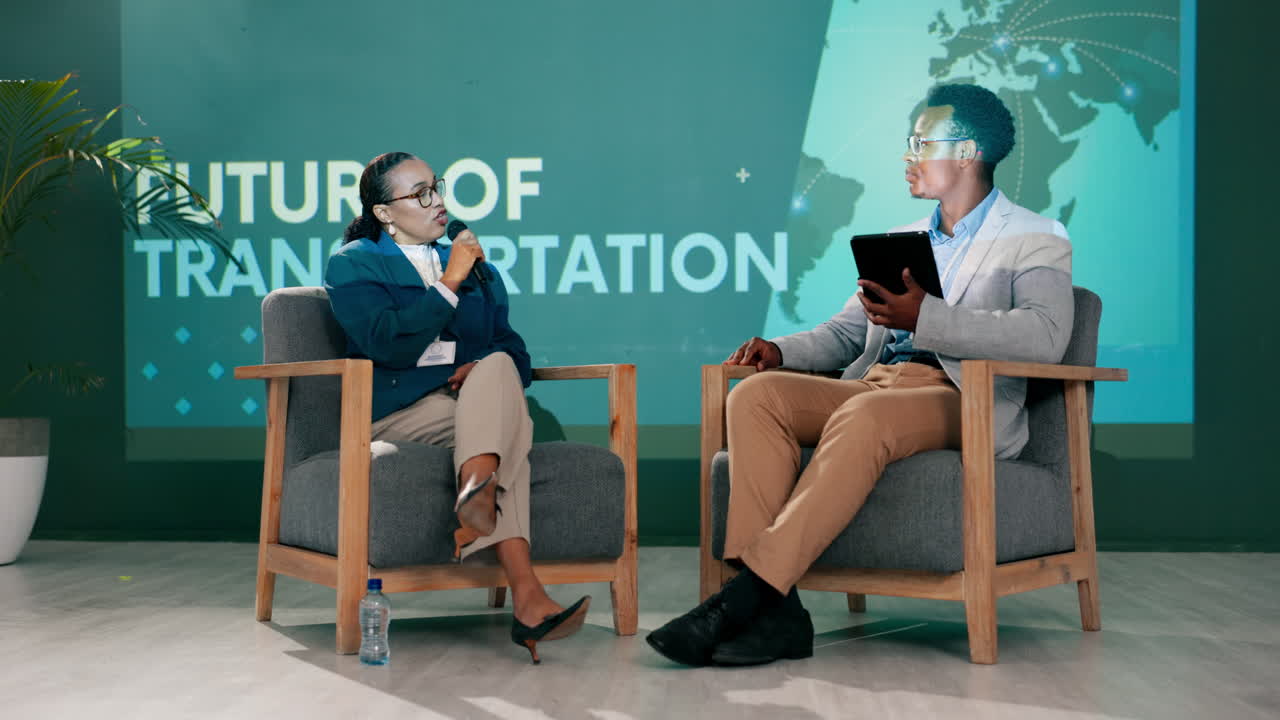 Two African American Professionals Discussing the Future of Transportation at a Conference