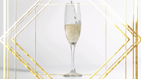 Animation-of-gold-pattern-over-glass-of-champagne-on-wthie-background