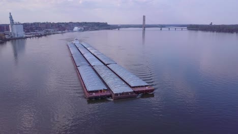 a beautiful aerial of a barge traveling on the mississippi river