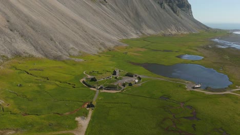 Witness the enchanting beauty of Iceland’s Viking Village as the drone glides over quaint buildings and lush greenery, revealing a rich tapestry of history and scenery.