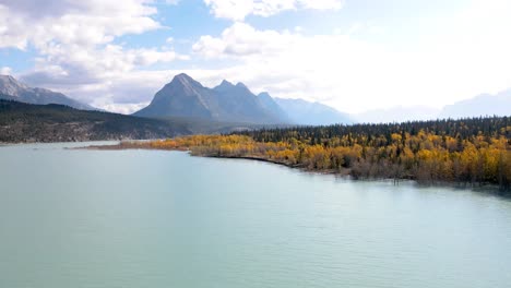 colorful autumn trees with beautiful mountains in the background