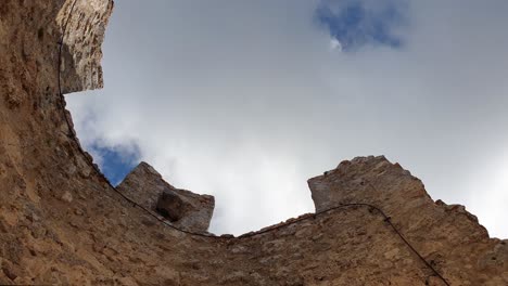 Interior-low-angle-orbit-shot-of-Rocca-Calascio-tower-battlements,-Italy