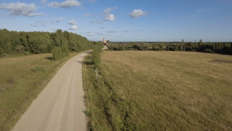 country road through fields and forest