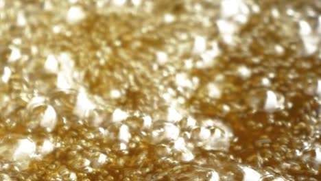 bubbling hot boiling golden color oil in close up view