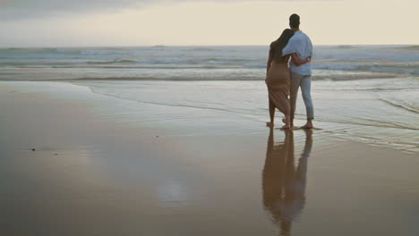 couple legs crossing ocean at summer closeup. embracing lovers rest foggy coast