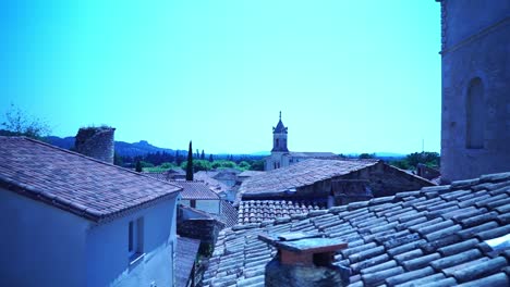 Drone-shot-over-the-rooftops-of-a-small-town-in-France-with-a-church-tower-on-the-horizon-Boulbon-France