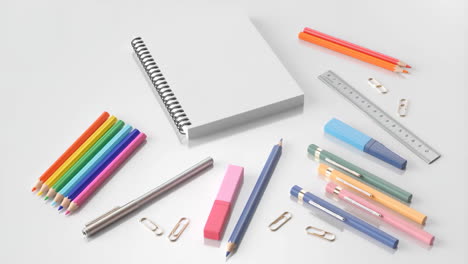 a collection of colorful school and office supplies on a white background