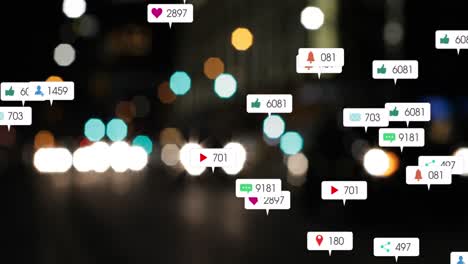 animation of social media icons and numbers over out of focus city and car lights