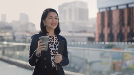 businesswoman walking in the city with coffee and documents