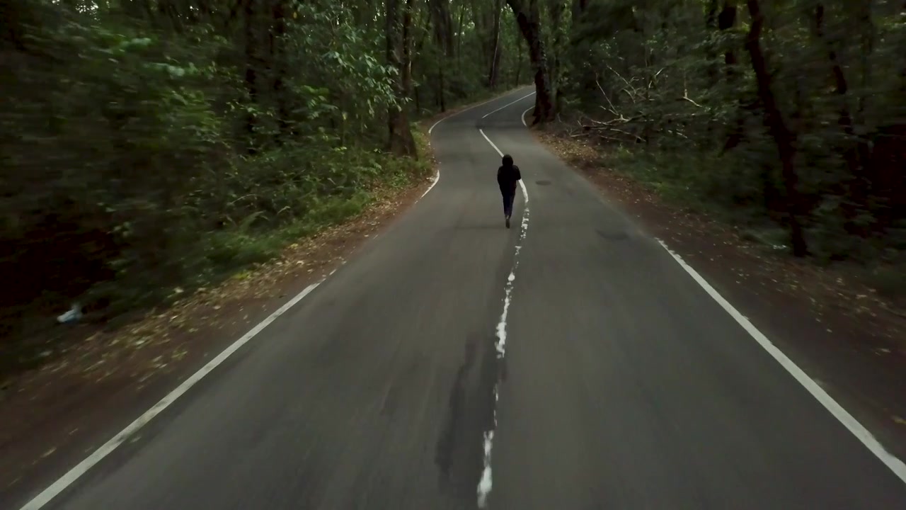 Someone running on a creepy street in Indonesia