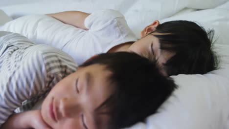 familia durmiendo juntos en la cama en el dormitorio 4k