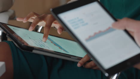 close up hands using digital tablet computer business people browsing financial graph information on screen brainstorming ideas in office meeting