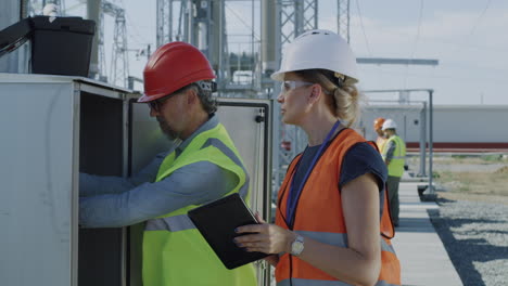 electrical engineers inspecting equipment at a power station