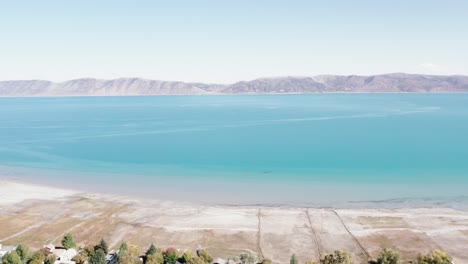 large blue utah lake with mountain range in the background aerial drone 4k