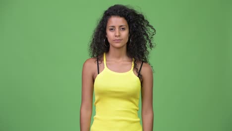 young beautiful hispanic woman pointing at camera