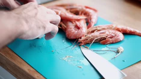 expert chef technique: close-up of shrimp prawn peeling and preparation - 4k culinary shot